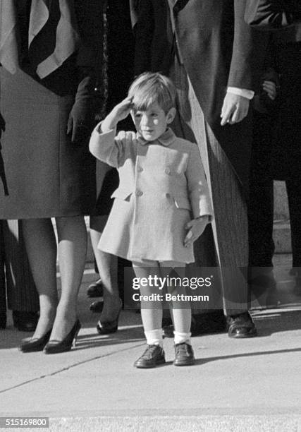 John F. Kennedy Jr., who turns three today, salutes as the casket of his father, the late President John F. Kennedy, is carried from St. Matthew's...