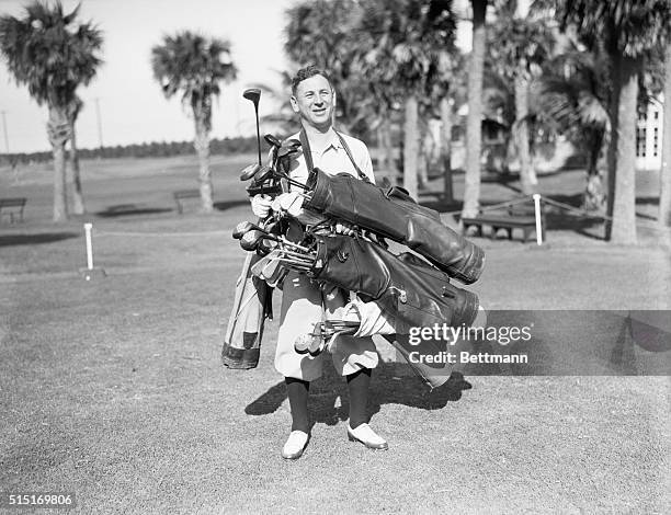 Palm Beach, FL: Rube Goldberg, wellknown artist and cartoonist, arriving at Palm beach Country Club, well prepared with a generous supply of clubs to...