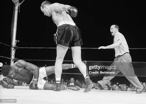 Yankee Stadium, NY- Heavyweight champion Floyd Patterson looks as though he is executing a stylish pirouette, but he is really in the act of falling...