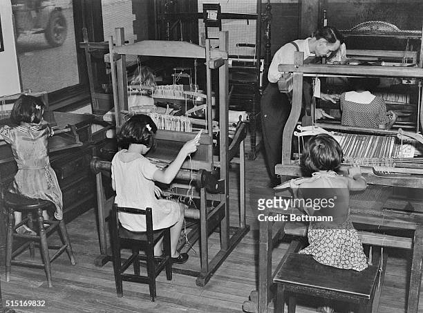 Girls working at looms at Hull house in Chicago, Ill., which was founded by Jane Addams.