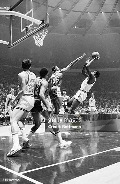 New York, NY- Knicks' Willis Reed attempts to shoot the ball over the outstretched arm of Wilt Chamberlain as Dave DeBusschere and Elgin Baylor...