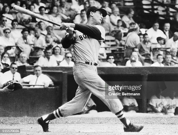 Detroit, Michigan-Boston slugger Ted Williams sends his 499th home run on its way during the 9th inning of Detroit-Boston game. Williams' homer tied...