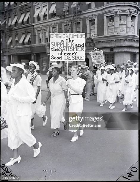 New York, NY- Bearing banners of various description Father Divine's "Angels," parade through Harlem to celebrate aquisition of the 500-acre "Spencer...