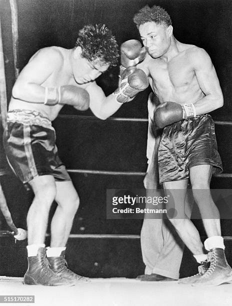 Los Angeles, CA:- Action picture during the featherweight title bout between Henry Armstrong, and Baby Arizmendi, defending champion, at Wrigley...