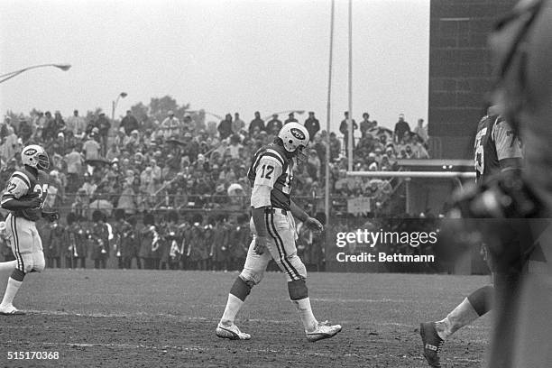 New York, NY- Head down and dejected, New York Jets' quarterback Joe Namath walks off the field and out of the game during the fourth quarter of his...