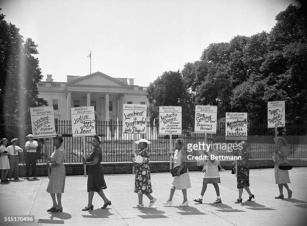 Washington, D.C.: Negro delegates from several states parade with signs in front of the White House to protest the mob slaying of four negroes in...