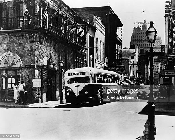 New Orleans, LA: Bourbon Street, Absinthe House is on the left, a street bus named "Desire" travels down the street.