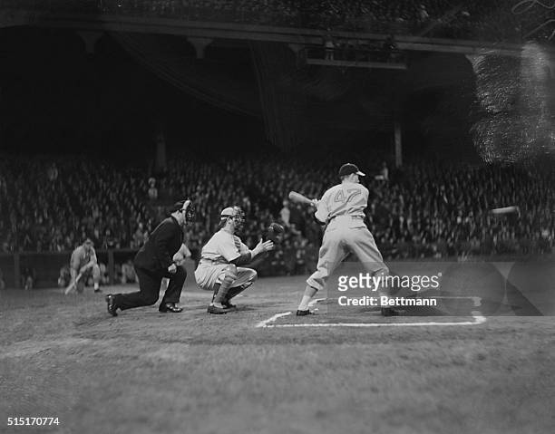 Lonny Frey of the Cincinnati Reds swings at a pitch during a game against the Brooklyn Dodgers at Ebbets Field during the first night game played in...