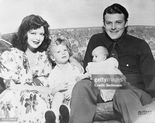 Clara Bow and Youngest Son in First Picture. Hollywood, Calif.: This family portrait of Rex Bell, cowboy actor, and his wife Clara Bow, former...