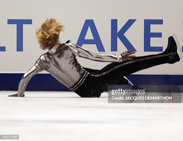 Current world champion, 19-year-old Evgeni Plushenko falls during the men's short program at the Olympic Ice Center, 12 Feruary 2002 during the XIXth...