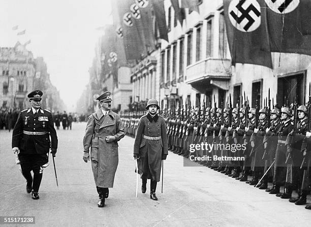 As Hitler Returned in Triumph to Berlin. Berlin, Germany: Chancellor Adolf Hitler, accompanied by Marshal Hermann Goering, inspecting honor troops...