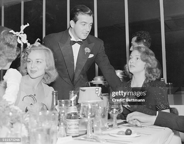 Anne Shirley and John Payne appear with Lana Turner at a party at Schwab's celebrating Turner's discovery there a year earlier.