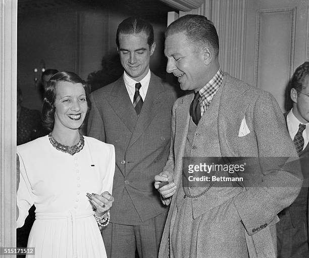 Lily Pons, singing star; Howard Hughes, noted flyer, and Lucius Beebe at the cocktail party given by Miss Pons at the Beverly Wilshire Hotel.