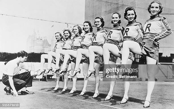 Precision leg work of the famous Rockettes is timed by Gene Snyder, co-director of the troupe. He was timing the new "Fete Francaise" revue that made...