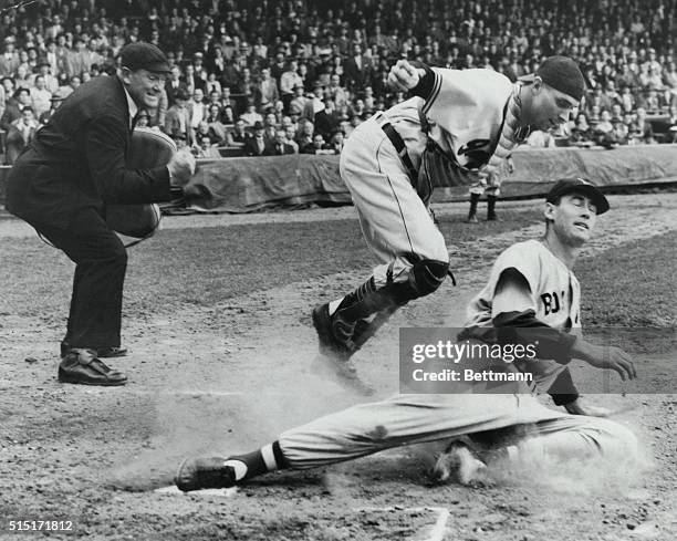 Ted Williams of the Boston Red Sox is called out at home plate against a game with the Cleveland Indians.