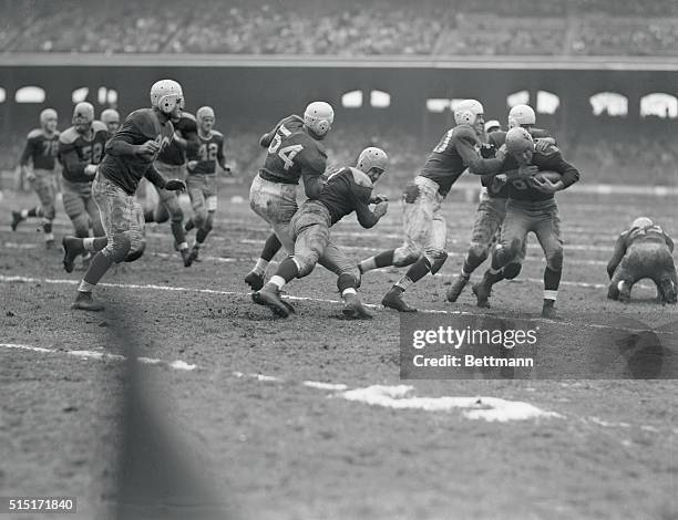 Chicago: Herman Rohrig, Packer half, is tackled after grabbing a Card fumble and running ten yards in second quarter of Cardinals-Green Bay Packers...