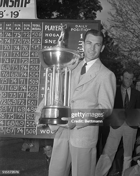 Ben Hogan, Texas sharpshooter, holding his trophy after winning the $1,000 top prize in the Goodall Round Robin Golf Tourney at Flushing, New York....