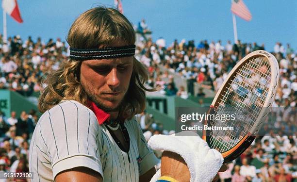 Swedish tennis star Bjorn Borg, with his trademark wooden racket, during a tennis match.