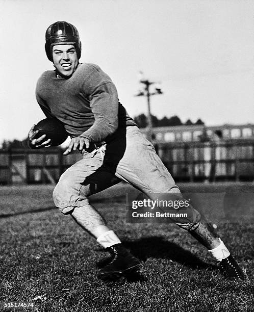 Otto Graham, football player for Northwestern University, is shown in a pose as if he's running with the football.