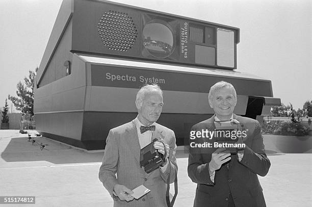Los Angeles: William J. McCune, , Chairman of the Board, and I. MacAllister Booth, , Chief Executive Officer of Polaroid Corporation, hold the new...