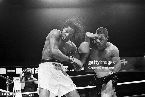 New York, NY- Mitch Green's hair goes flying as undefeated Mike Tyson rocks him with a fistic barage during their 5/20 bout here. Tyson won the fight...