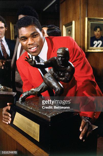 New York, New York: Georgia running back Herschel Walker, the most dominant player in college football the last three years, adds the Heisman Trophy...