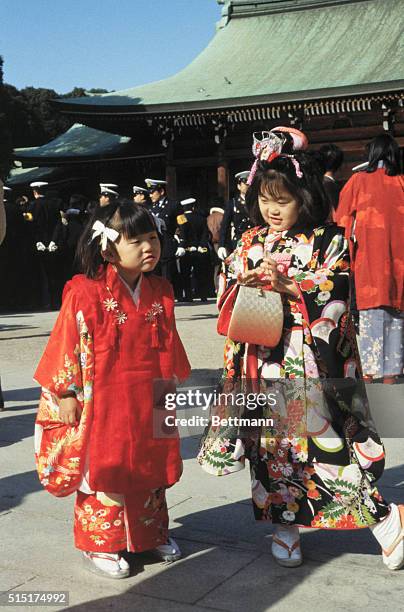 Tokyo, Japan: Yuko Azuma and her 3-year-old sister, Aiko, , walk together in colorful kimono as they visit the Meiji Shrine here for the New Year...