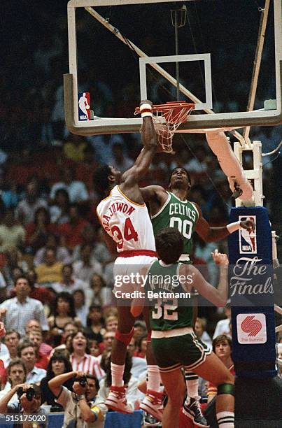 Houston: NBA Finals Rockets vs Celtics. Houston Rockets Akeem Olajuwon slams the ball into the basket for two points during the first period of the...