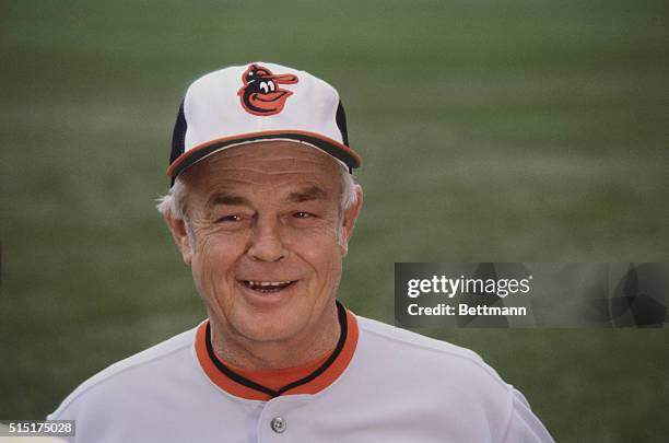 Close up Baltimore Orioles baseball team's manager Earl Weaver, standing alone outside and wearing an Orioles hat.