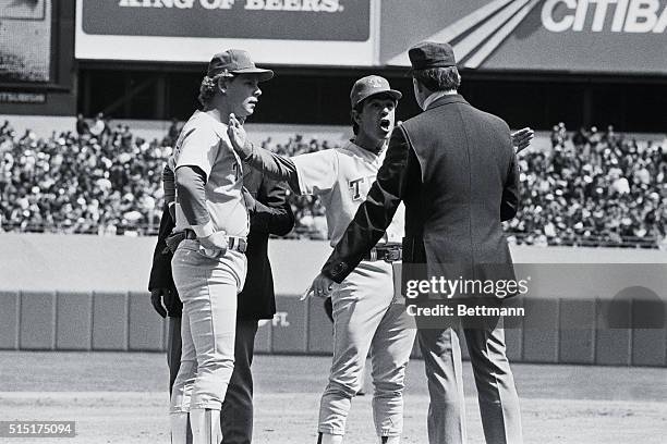 New York: Bobby Valentine, manager of the Texas Rangers shows 3rd base umpire Vic Voltaggio that Willie Randolph was out by this much at third. Texas...