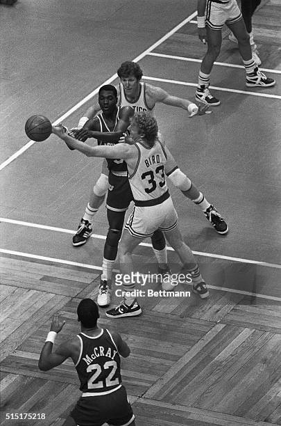 Houston Rockets' Akeem Olajuwon is sandwiched by Boston Celtics' Bill Walton and Larry Bird during game one of the NBA playofffs at Boston Garden,...