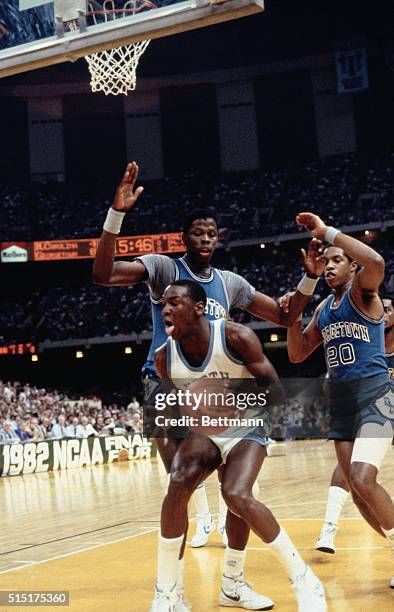 Action during the NCAA Championship as Patrick Ewing of Georgetown, defends against North Carolina's Michael Jordan.