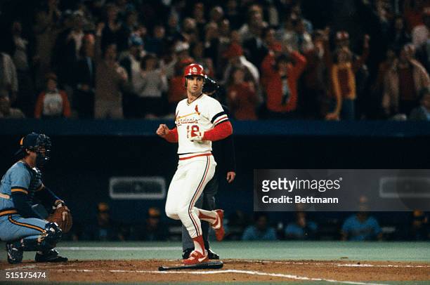 The St. Louis Cardinals Dane Iorg scores on a hit by teammate Willie McGee during the second inning of the sixth game of the 1982 World Series...