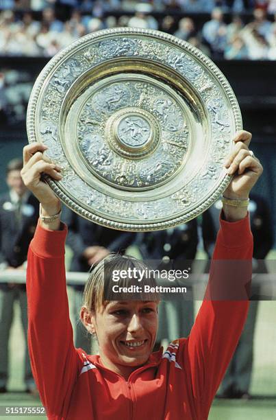 Martina Navralitova holds the Wimbledon Women's Singles trophy aloft after she beat Andrea Jeager for the title.