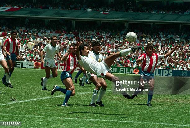 World Cup, Mexico City: Mexico's Hugo Sanchez leaps off the pitch as he attempts to take control of the ball in the first half as he keeps the...