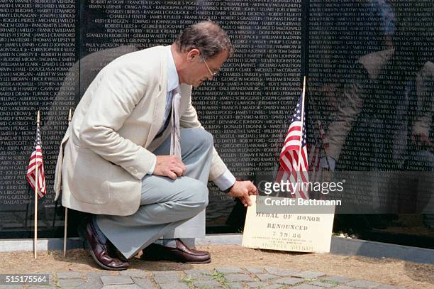 Vietnam veteran Charles Litkey places a manila envelope containing his Medal of Honor at the Vietnam Veteran's Memorial. He was renouncing his medal...