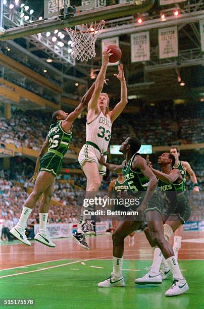 Celtics' Larry Bird goes up between Bucks' Jerry Reynolds and Craig Hodges for basket in the 1st quarter of the second game of the NBA semifinals at...