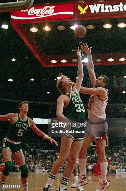 Celtics' Larry Bird tries to block a shot by Bulls' Dave Corzine in the second quarter of game three of their playoff, 4/22. Boston beat Chicago...