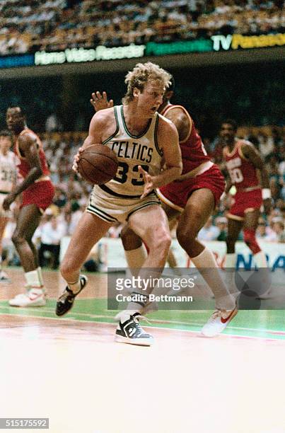Larry Bird pivots past Rocket's Rodney McCray during third quarter action of game two of the NBA Championship at Boston Garden, 5/29. Bird scored 31...