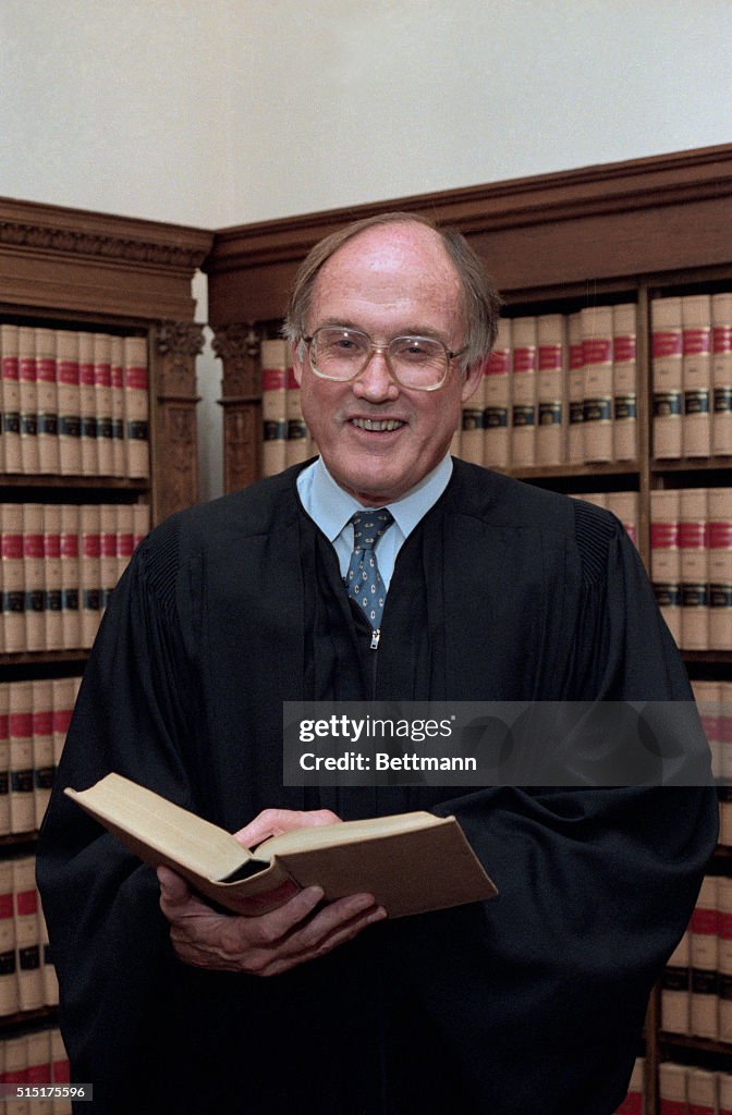 Scotus Rendquist Supreme Court Associate Justice William Rehnquist holds a picture ...