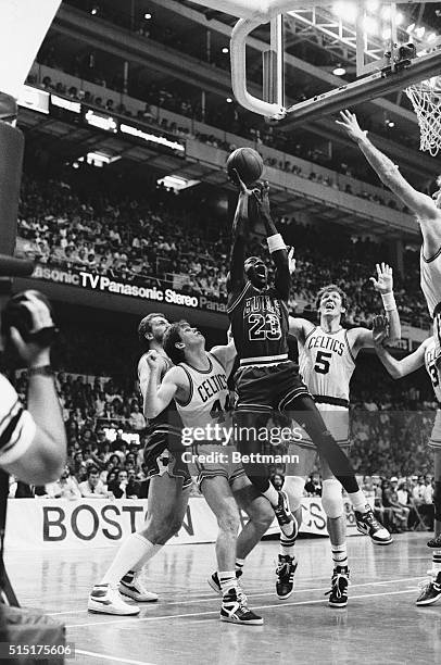 Chicago Bulls' Michael Jordan drives past Celtics' Danny Ainge and Bill Walton during 4th quarter action at Boston Garden. Jordan set an NBA playoff...