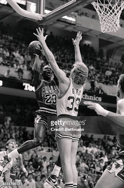 Chicago Bulls' Michael Jordan goes up for basket as Celtics' guard Larry Bird attempts to block him during the first quarter action of game 2 of the...