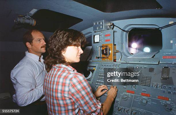 Space shuttle mission specialist Dr. Sally A. Ride and pilot Frederick H. Hauck, members of the STS-7 astronaut crew, go over procedures in operating...