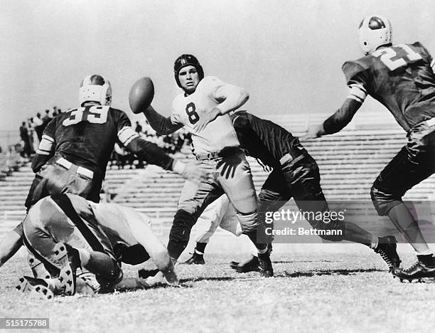 Playing for Texas Christian University, O'Brien calmly aims his pass while surrounded by Arkansas Red Shirts. Coolness in a pinch was one of Heisman...