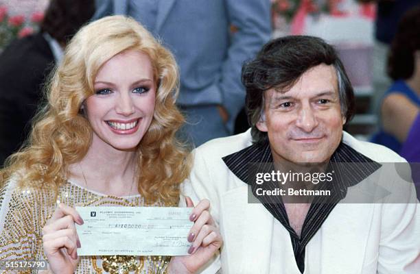 Playmate of the Year Shannon Lee Tweed, holding check, with Hugh Hefner at the Playmate of the Year party.