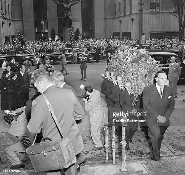 Babe's last journey...Piled high with flowers, the casket containing the body of the late Babe Ruth is carried into St. Patrick's Cathedral, August...