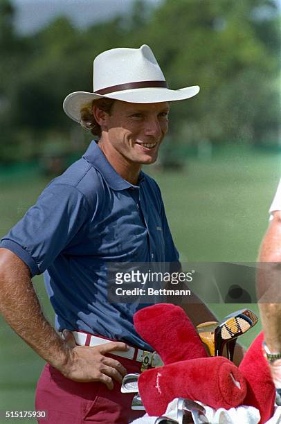 Bernhard Langer of West Germany seemed in a good mood as he prepared to hit a few practice balls on the PGA National golf club course 8/5. Langer is...