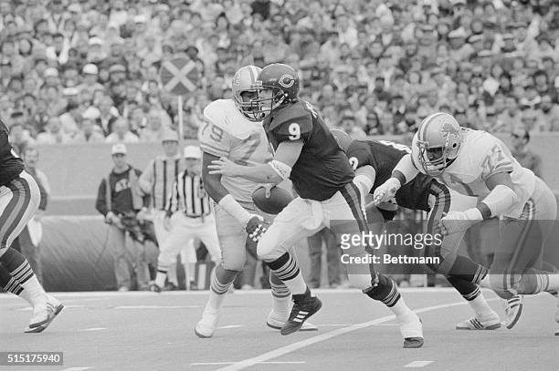 Bear quarterback Jim McMahon tries to run away from Lions' Keith Ferguson but is sacked for a short loss in the third quarter of game. Other Lion...