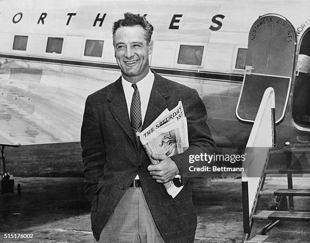 Smiling Lou Gehrig, husky first base star of the New York Yankees, pictured when he left the airplane that brought him to the Mayo Clinic where he...