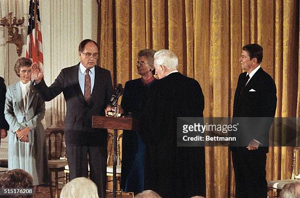 Retiring Supreme Court Chief Justice Warren Burger swears in William H. Rehnquist as Chief Justice of the United States at the White House. Looking...